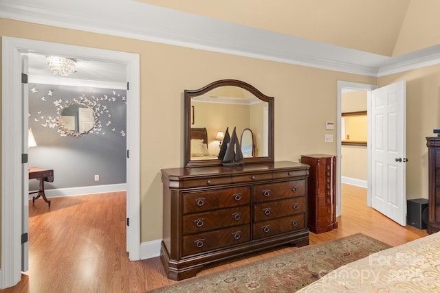 bedroom featuring crown molding, a chandelier, and light hardwood / wood-style flooring