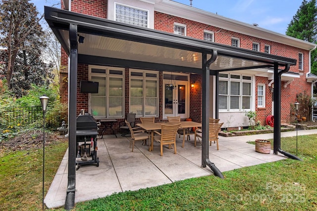 back of house with a yard and a patio area