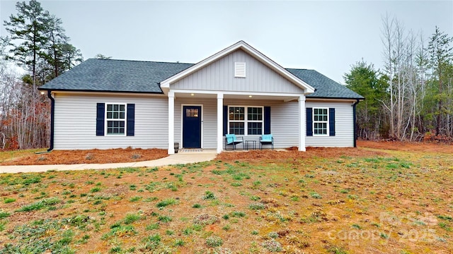 view of front of home with a porch and a front yard