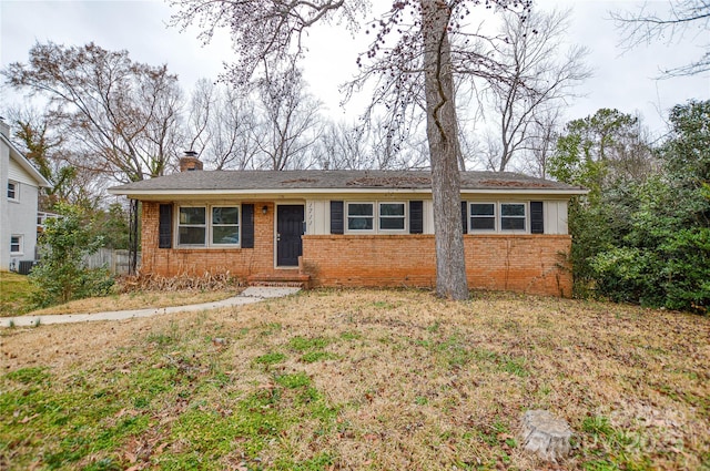 single story home featuring a front lawn and central air condition unit