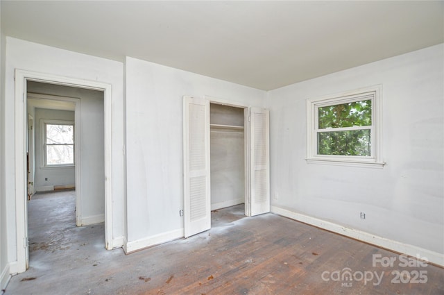 unfurnished bedroom featuring dark hardwood / wood-style flooring and a closet