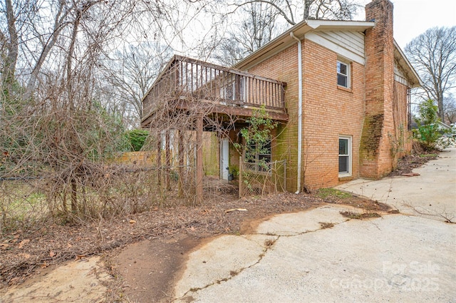 view of property exterior with a wooden deck