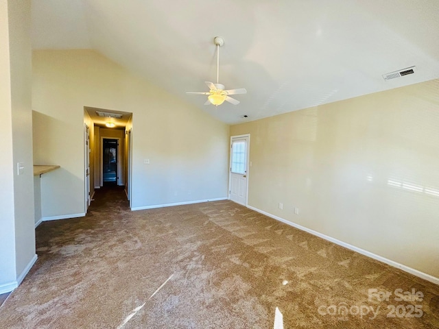 carpeted empty room featuring a ceiling fan, lofted ceiling, visible vents, and baseboards