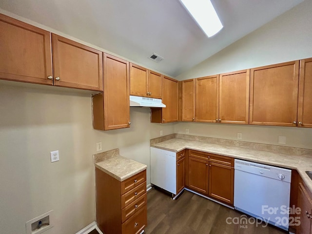 kitchen with dishwasher, lofted ceiling, dark wood-style floors, brown cabinets, and under cabinet range hood