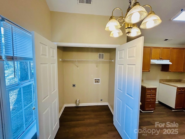 washroom featuring washer hookup, visible vents, dark wood-type flooring, electric dryer hookup, and laundry area