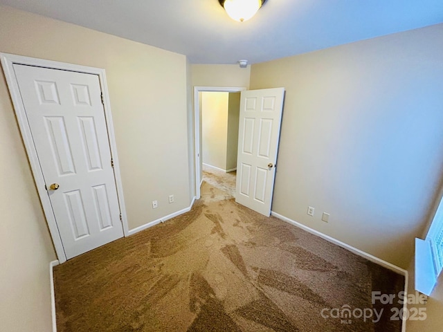 unfurnished bedroom with carpet and baseboards