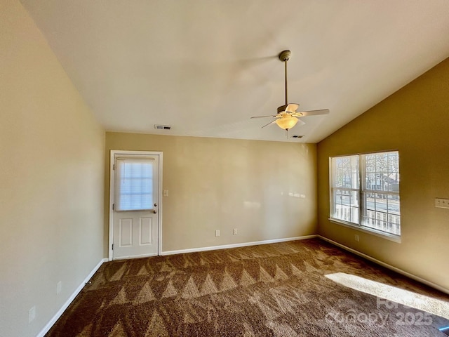 unfurnished room with carpet, visible vents, vaulted ceiling, and baseboards