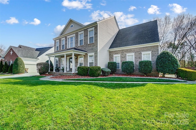 view of front of house with covered porch, a front lawn, and brick siding