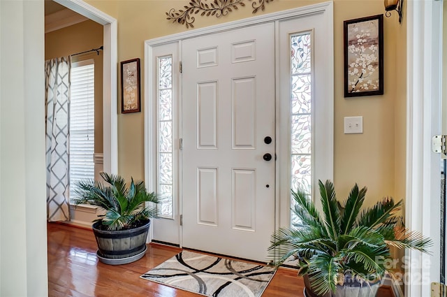 entryway with plenty of natural light and wood finished floors