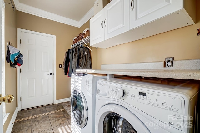 laundry room with dark tile patterned flooring, baseboards, ornamental molding, independent washer and dryer, and cabinet space