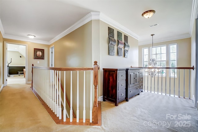 hallway with crown molding, visible vents, and light colored carpet