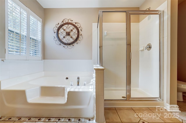 full bath with toilet, a shower stall, a bath, and tile patterned floors