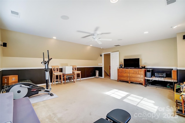 workout area with lofted ceiling, light carpet, ceiling fan, and visible vents