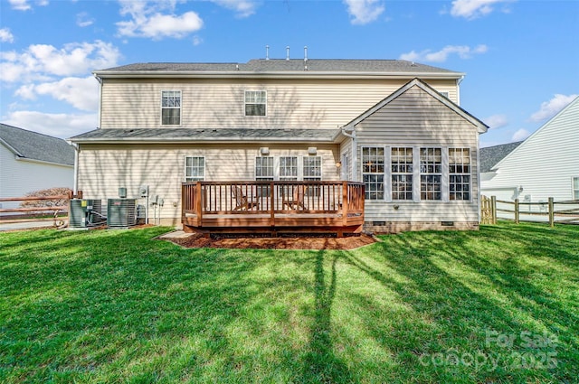 rear view of house featuring crawl space, fence, a deck, and a yard