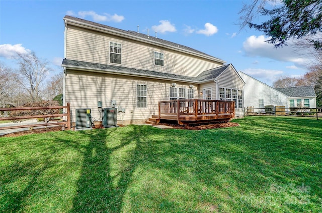 back of house with a deck, a lawn, cooling unit, and a fenced backyard