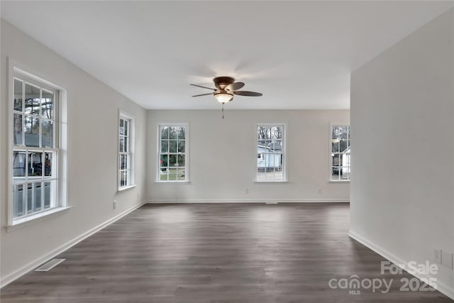 unfurnished room featuring dark hardwood / wood-style floors and ceiling fan