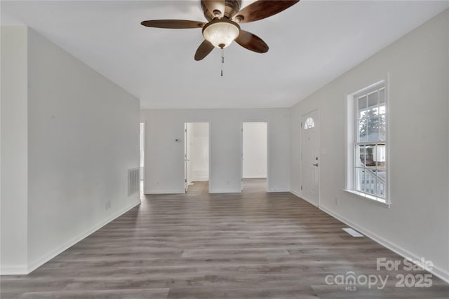 unfurnished living room with hardwood / wood-style flooring and ceiling fan