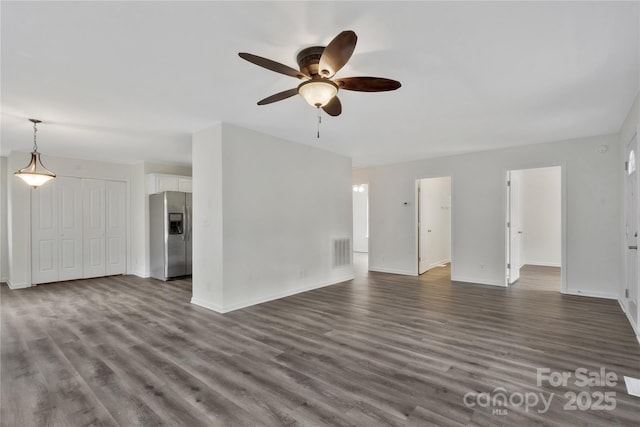 unfurnished living room with ceiling fan and dark hardwood / wood-style flooring