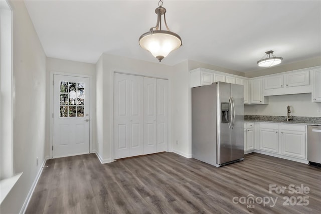 kitchen featuring white cabinetry, pendant lighting, dark hardwood / wood-style flooring, and stainless steel appliances