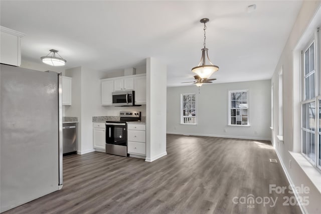 kitchen with ceiling fan, wood-type flooring, white cabinets, and appliances with stainless steel finishes