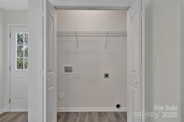 clothes washing area with hookup for a washing machine, hookup for an electric dryer, and light wood-type flooring