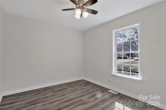 spare room featuring dark hardwood / wood-style flooring and ceiling fan