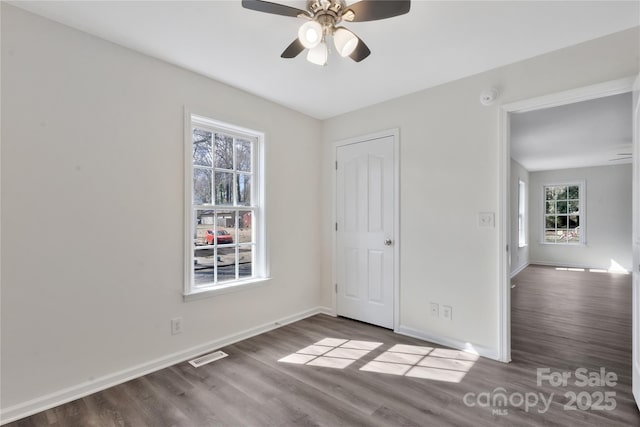 unfurnished bedroom with dark wood-type flooring and ceiling fan