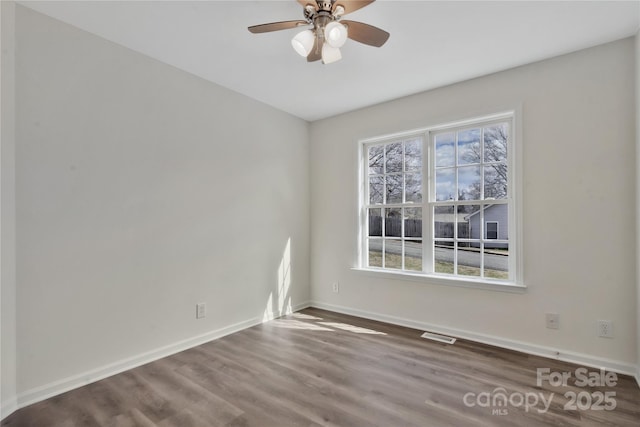 spare room featuring wood-type flooring and ceiling fan