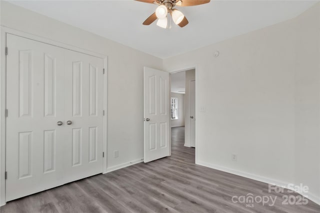 unfurnished bedroom with ceiling fan, light hardwood / wood-style floors, and a closet