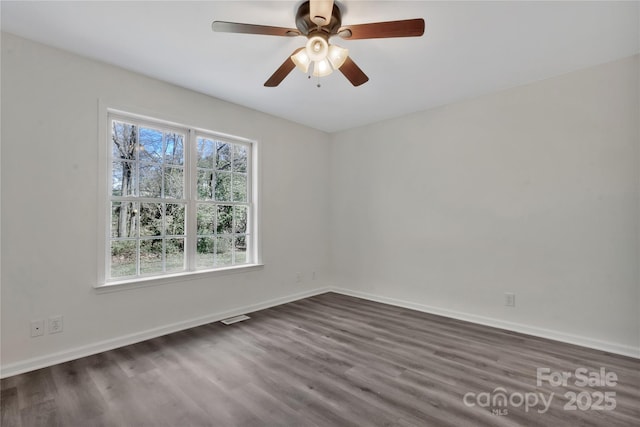 unfurnished room featuring ceiling fan and dark hardwood / wood-style flooring