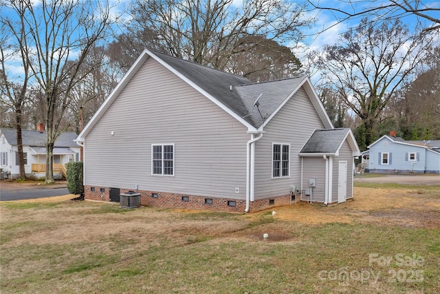 view of home's exterior featuring cooling unit and a yard