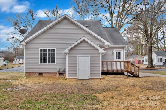 rear view of property featuring a yard and a deck