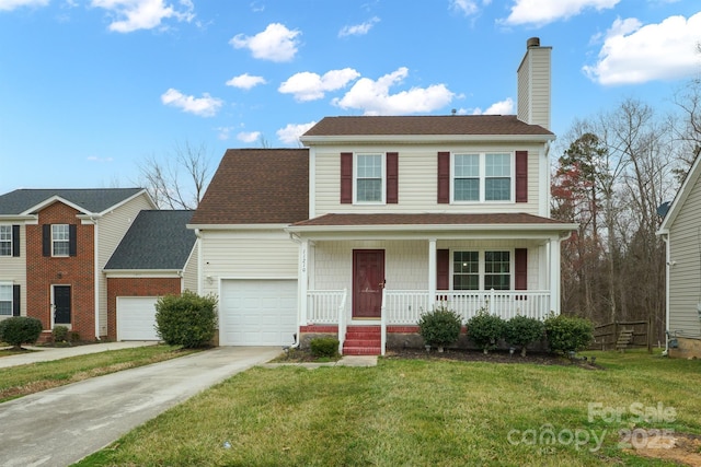 view of front of house with a front yard, a garage, and a porch