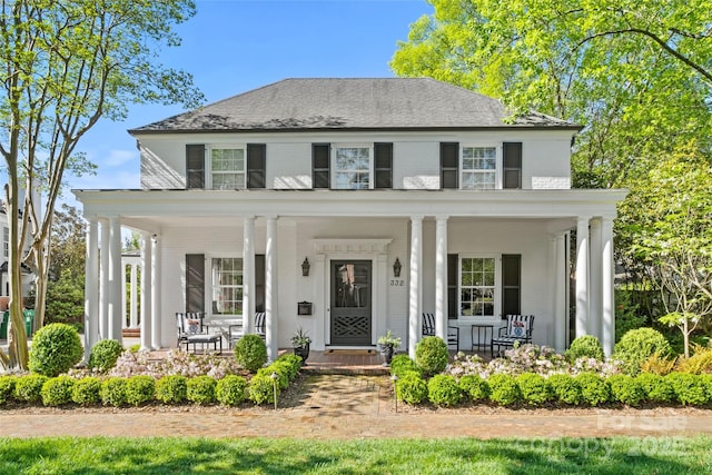 view of front of house featuring a porch and brick siding