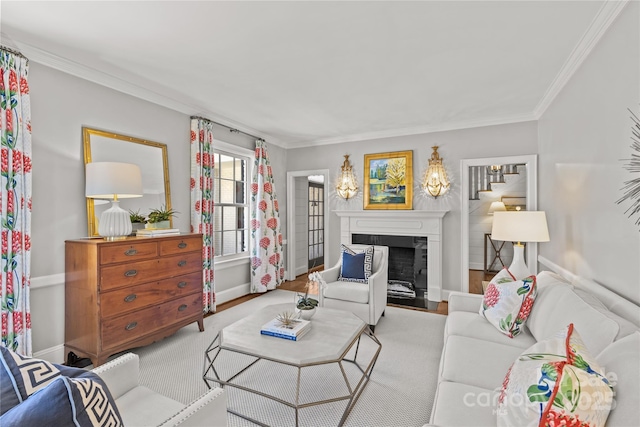 living room featuring ornamental molding, a fireplace, and baseboards