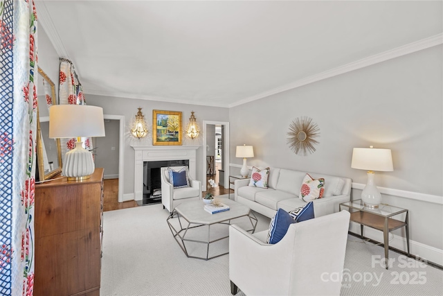 living room featuring a fireplace with flush hearth, ornamental molding, and baseboards