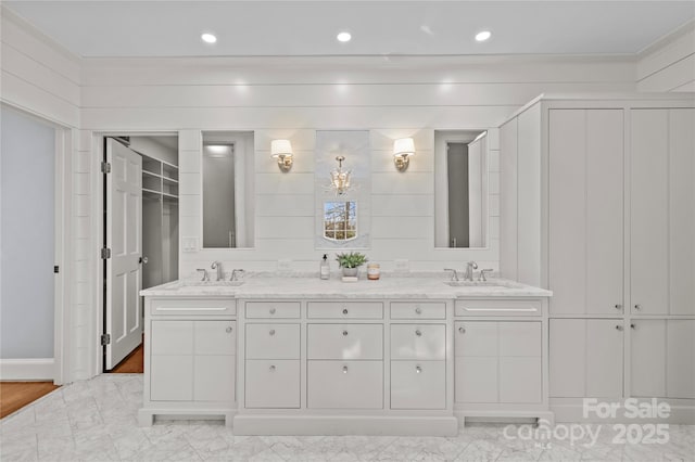 full bathroom with marble finish floor, a sink, and double vanity