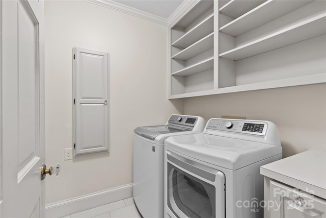 clothes washing area featuring laundry area, baseboards, ornamental molding, and independent washer and dryer