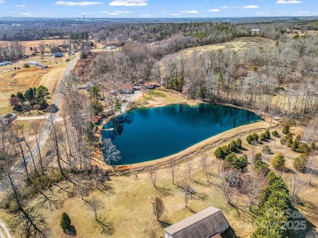 aerial view featuring a water view and a forest view