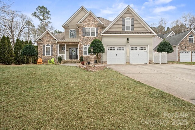 craftsman house with a standing seam roof, a garage, a front lawn, concrete driveway, and stone siding