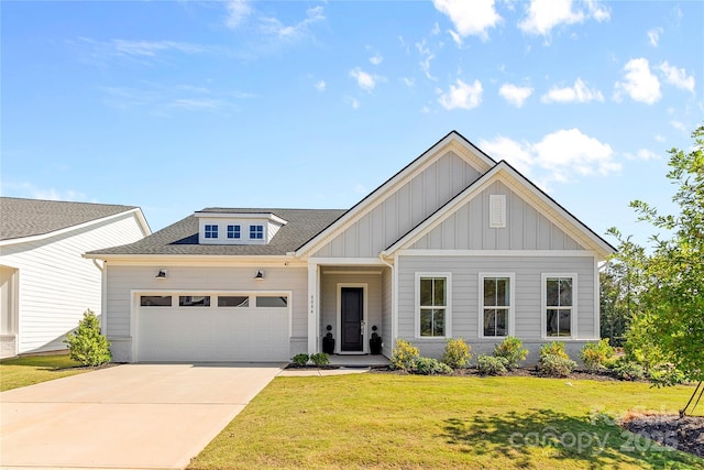 view of front of home with a garage, driveway, a shingled roof, board and batten siding, and a front yard