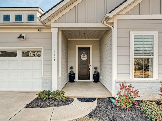 entrance to property featuring a garage and board and batten siding