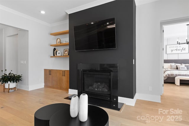 living room with recessed lighting, a fireplace with flush hearth, baseboards, light wood finished floors, and crown molding