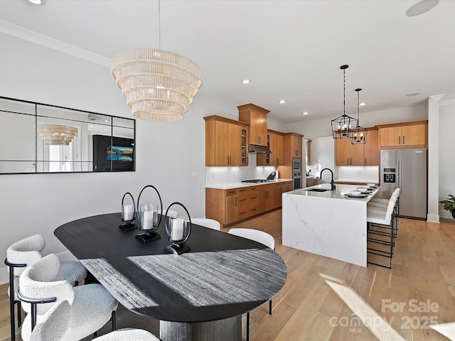 kitchen featuring hanging light fixtures, an inviting chandelier, stainless steel appliances, and light countertops