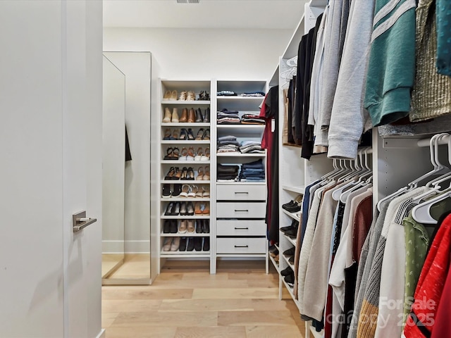 spacious closet with light wood-style flooring and visible vents