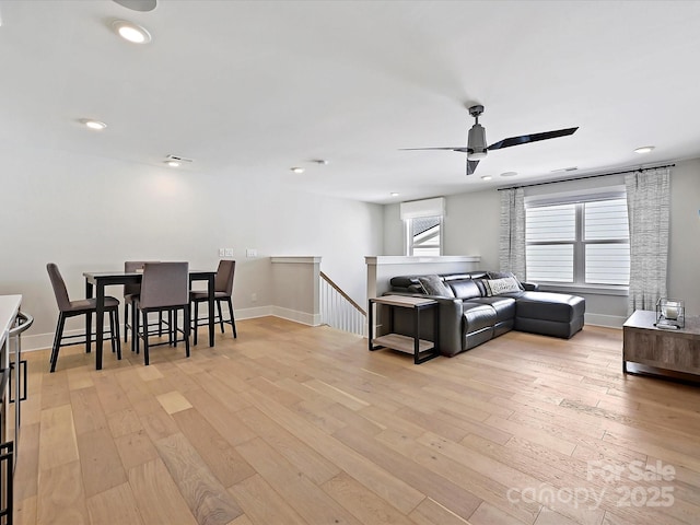 living area with light wood-style flooring and baseboards