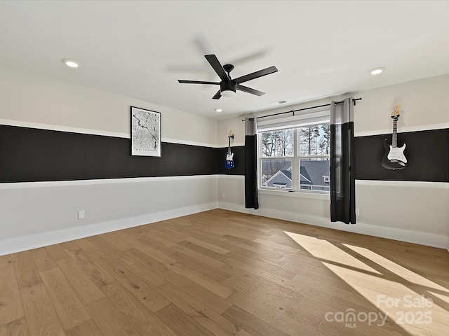 unfurnished room featuring baseboards, light wood-type flooring, visible vents, and recessed lighting