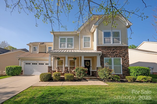 3216 Bridgewick Rd, Waxhaw, NC 28173 - view of front facade with a front lawn, driveway, stone siding, covered porch, and an attached garage