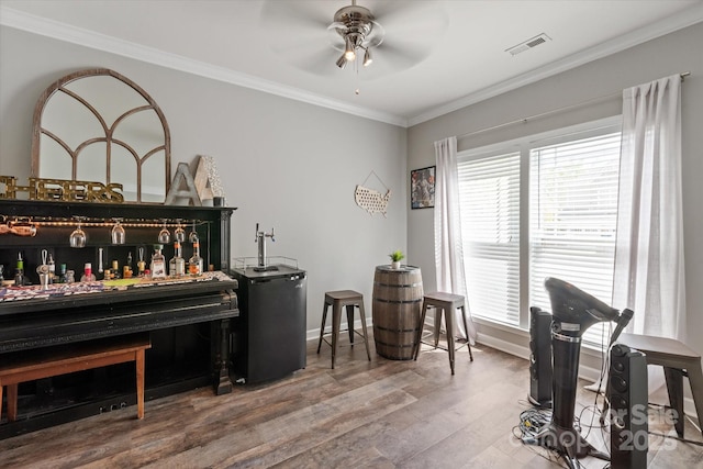 3216 Bridgewick Rd, Waxhaw, NC 28173 - interior space with a ceiling fan, crown molding, wood finished floors, a healthy amount of sunlight, and visible vents