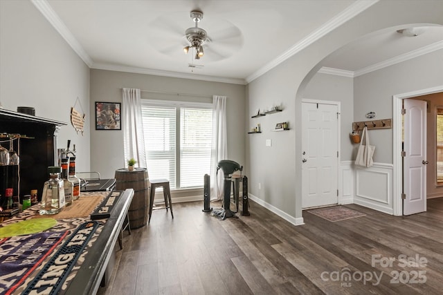 3216 Bridgewick Rd, Waxhaw, NC 28173 - interior space featuring ornamental molding, arched walkways, a ceiling fan, and dark wood-style flooring